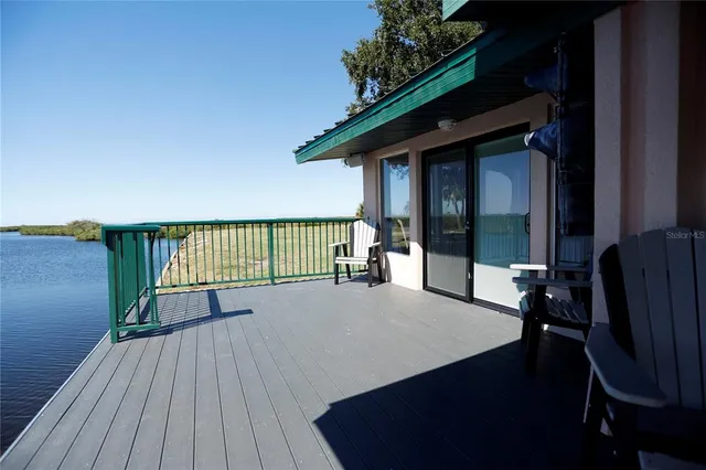 a view of balcony with wooden floor and seating space