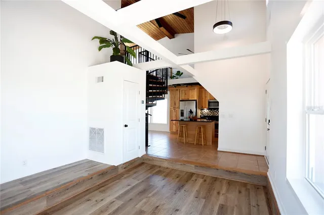 a view of kitchen and hall with wooden floor