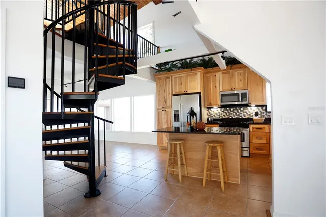 a kitchen with granite countertop a stove a sink and a microwave