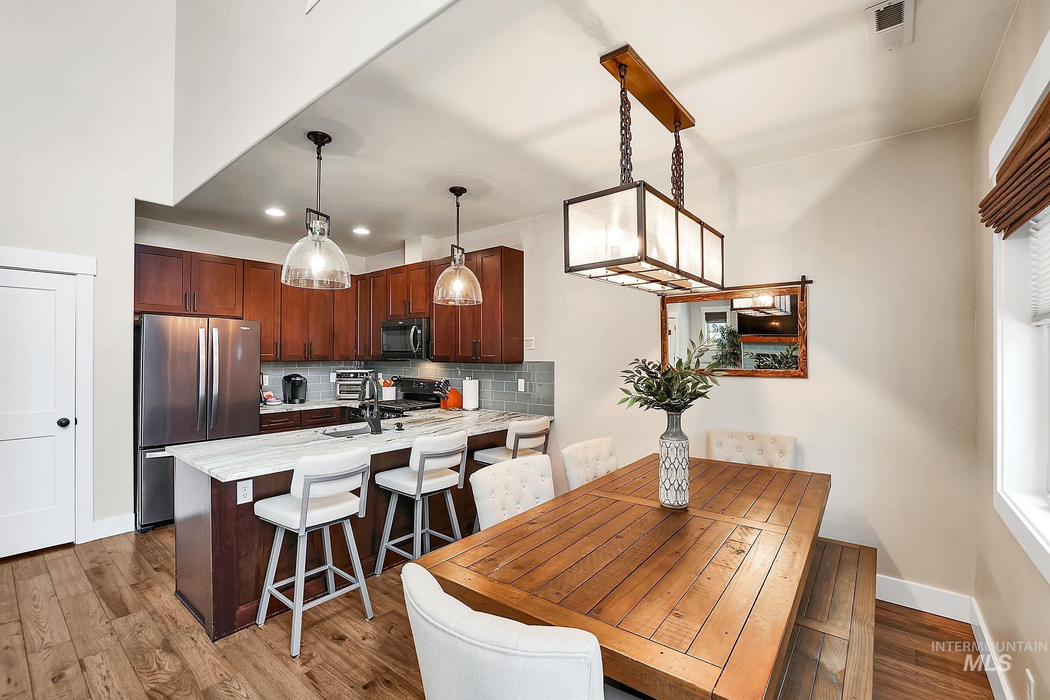 609 Blue Water Circle McCall, ID 83638 - Photo 10 of 45 Dining space featuring dark wood-style flooring and recessed lighting