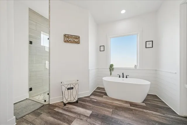 a spacious bathroom with a bathtub and shower