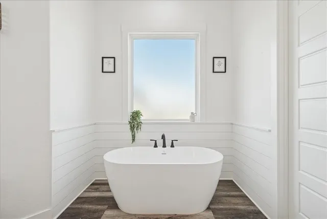 a white bath tub sitting in a bathroom