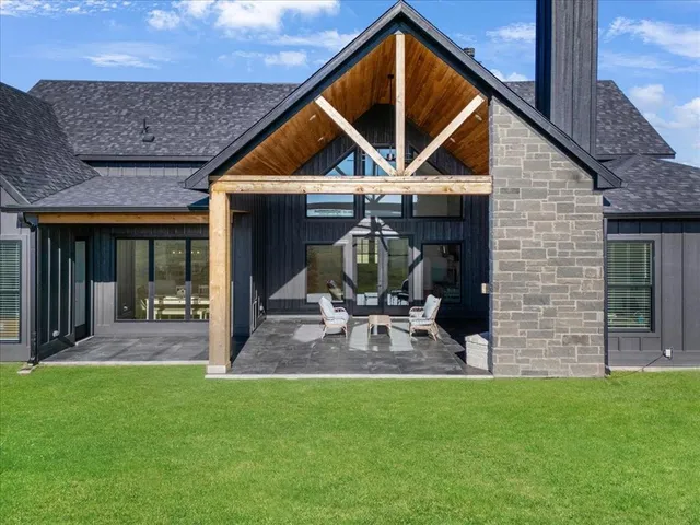 a front view of a house with a yard table and chairs