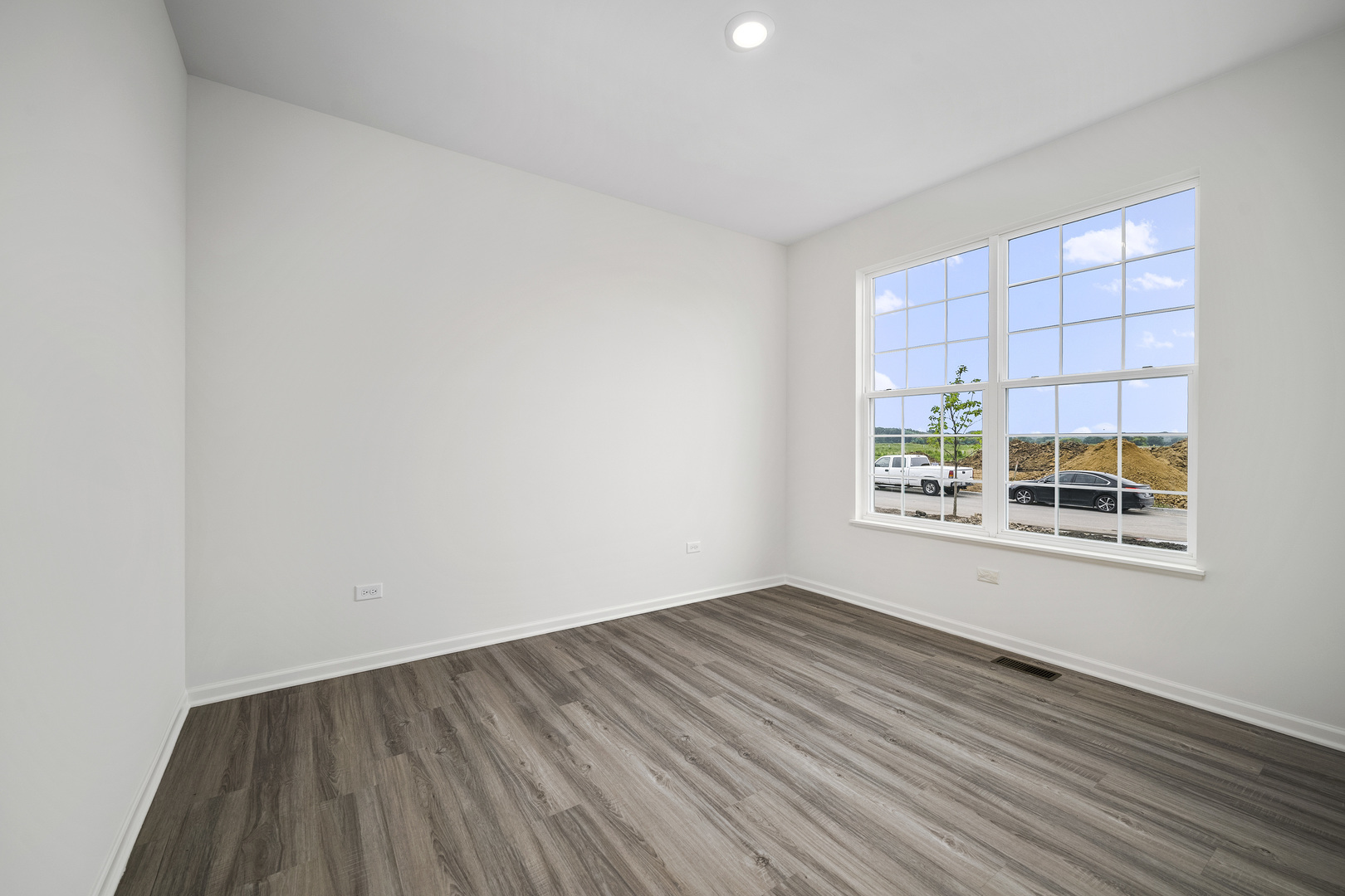 3668 Edelweiss Road Elgin, IL 60124 - Photo 4 of 23 an empty room with wooden floor and windows