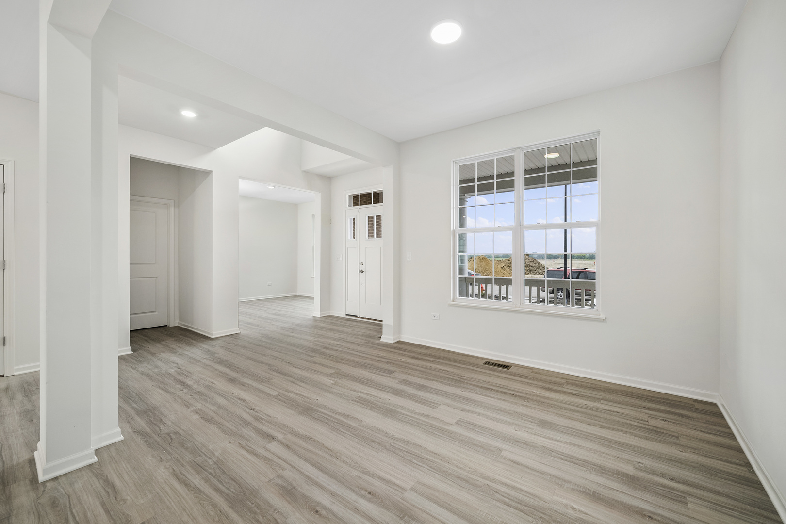 3668 Edelweiss Road Elgin, IL 60124 - Photo 6 of 23 an empty room with wooden floor and windows
