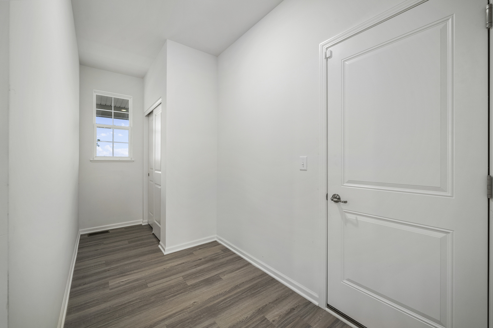 3668 Edelweiss Road Elgin, IL 60124 - Photo 7 of 23 a view of an empty room with wooden floor and a window