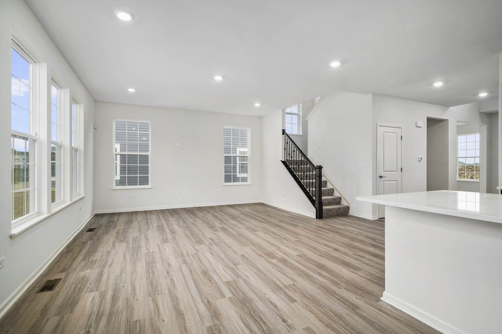 3668 Edelweiss Road Elgin, IL 60124 - Photo 9 of 23 a view of an empty room with wooden floor and stairs
