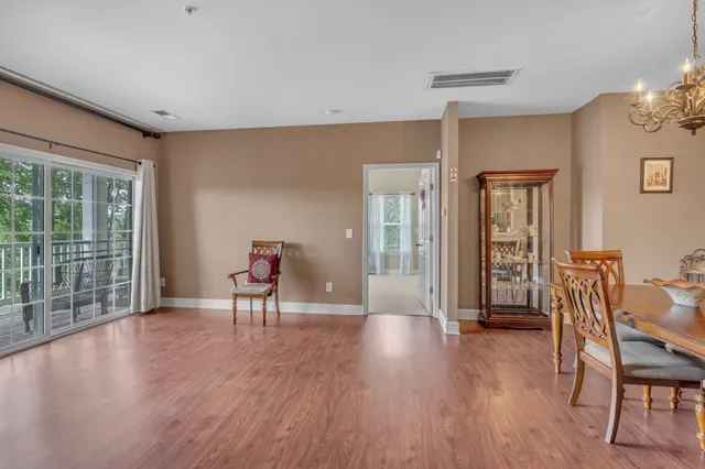 a view of a livingroom with furniture wooden floor and a window
