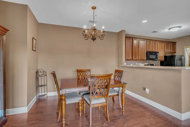 a view of a dining room with furniture wooden floor and chandelier