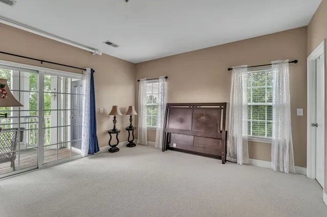 an empty room with furniture and windows