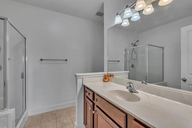 a bathroom with a sink vanity granite and a mirror