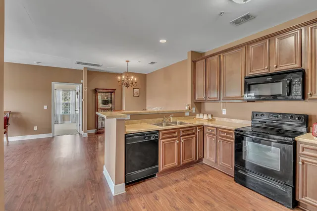 a kitchen with stainless steel appliances granite countertop a stove top oven and sink