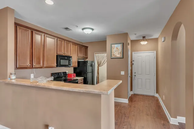 a kitchen with stainless steel appliances a refrigerator sink and cabinets