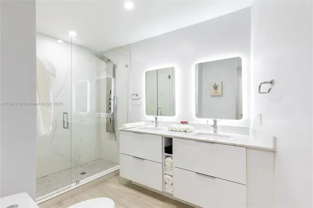 a bathroom with a shower sink and mirror