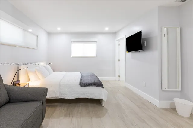 a bedroom with a bed and a flat screen tv