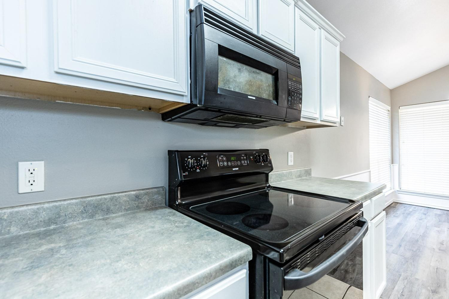 2006 100th Street Lubbock, TX 79423 - Photo 11 of 31 a kitchen with a stove and a microwave