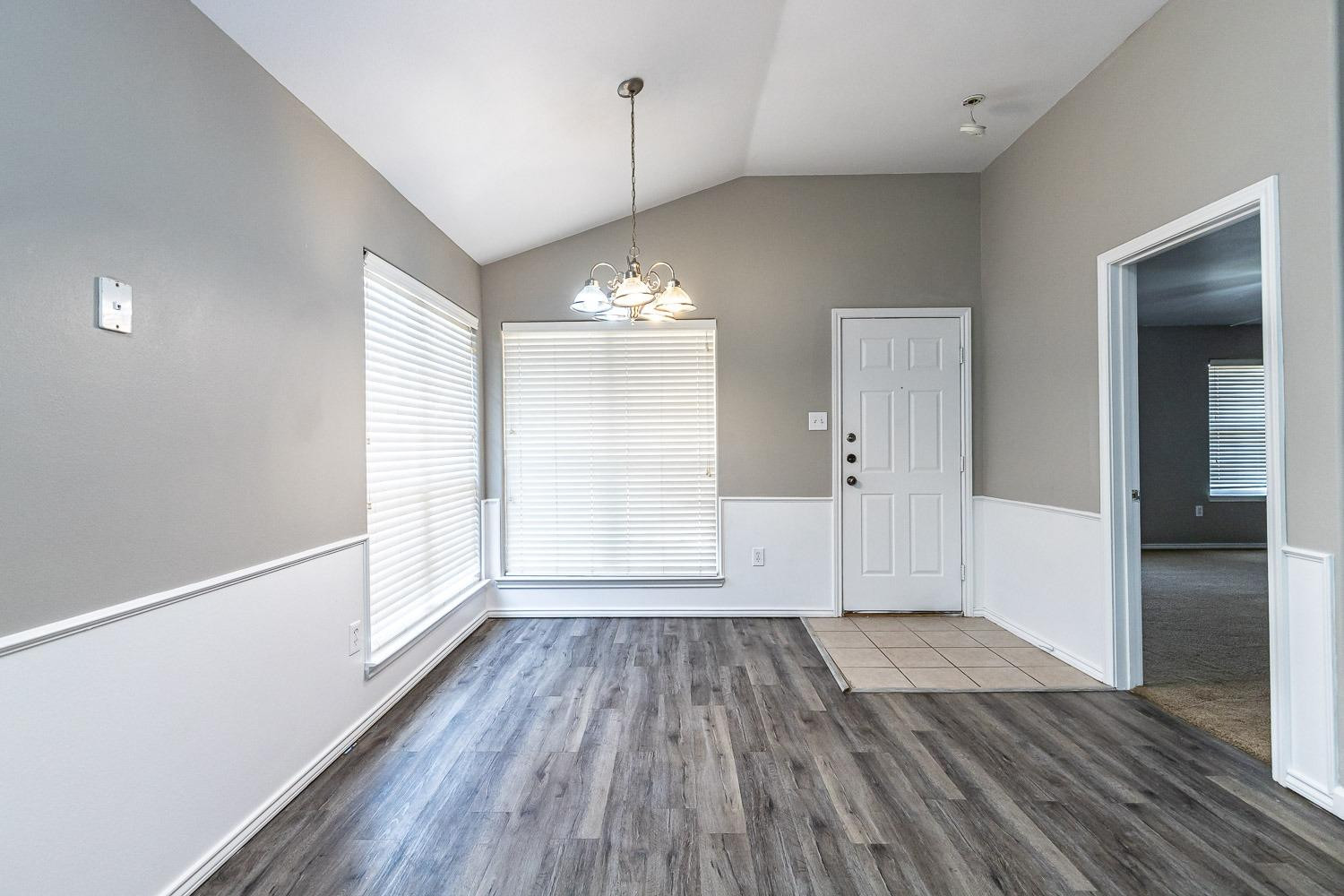 2006 100th Street Lubbock, TX 79423 - Photo 12 of 31 wooden floor in an empty room with a window
