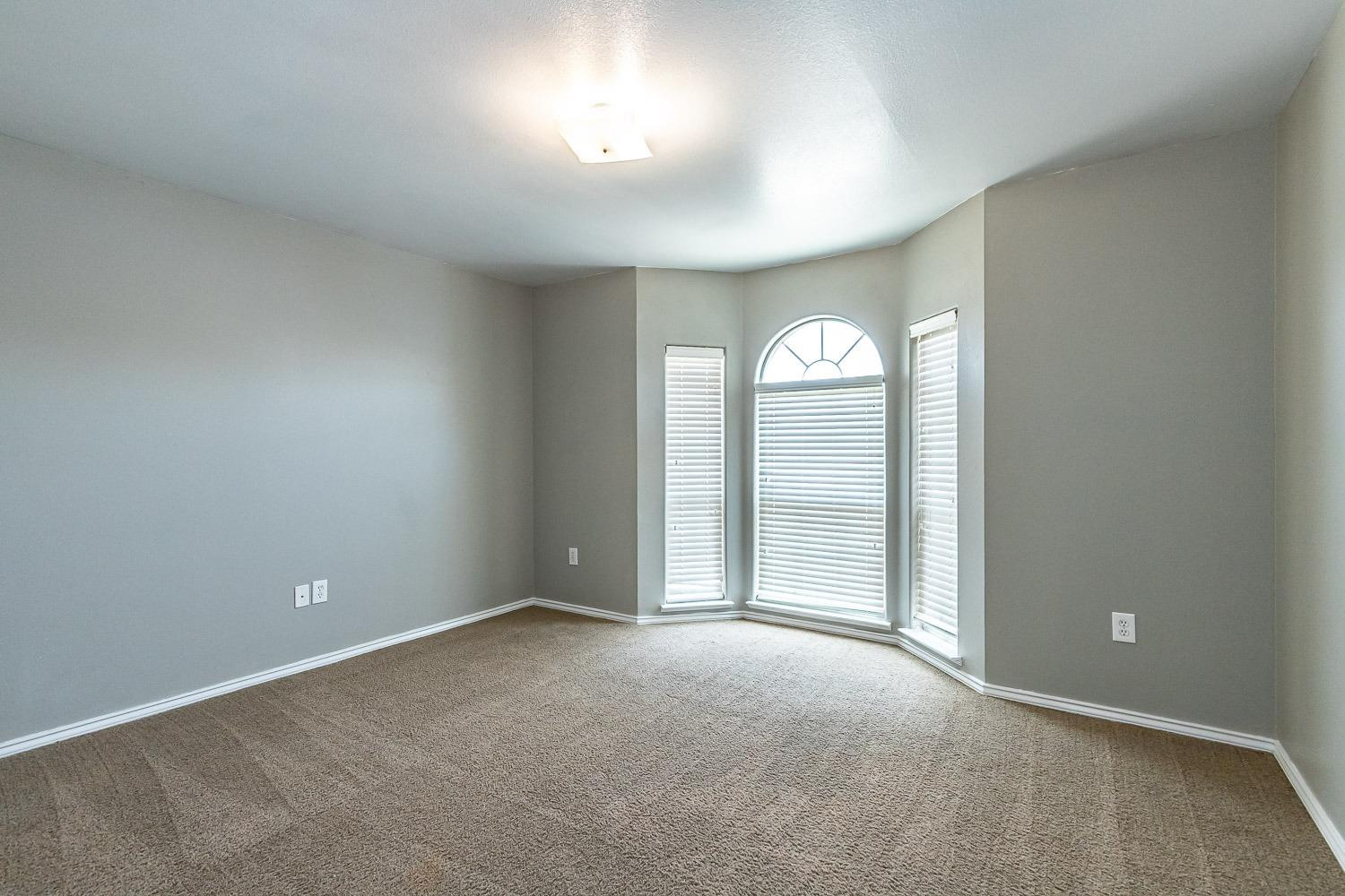 2006 100th Street Lubbock, TX 79423 - Photo 21 of 31 an empty room with a vanity and a window