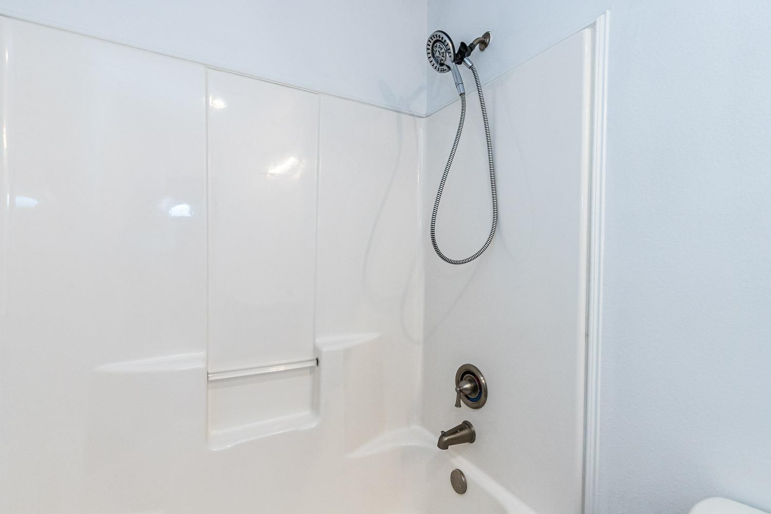 2006 100th Street Lubbock, TX 79423 - Photo 24 of 31 a bathroom with a bath tub with a shower