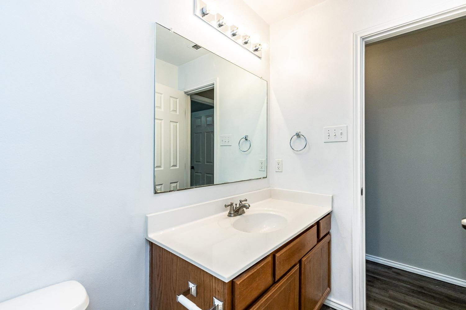 2006 100th Street Lubbock, TX 79423 - Photo 25 of 31 a bathroom with a sink and a mirror