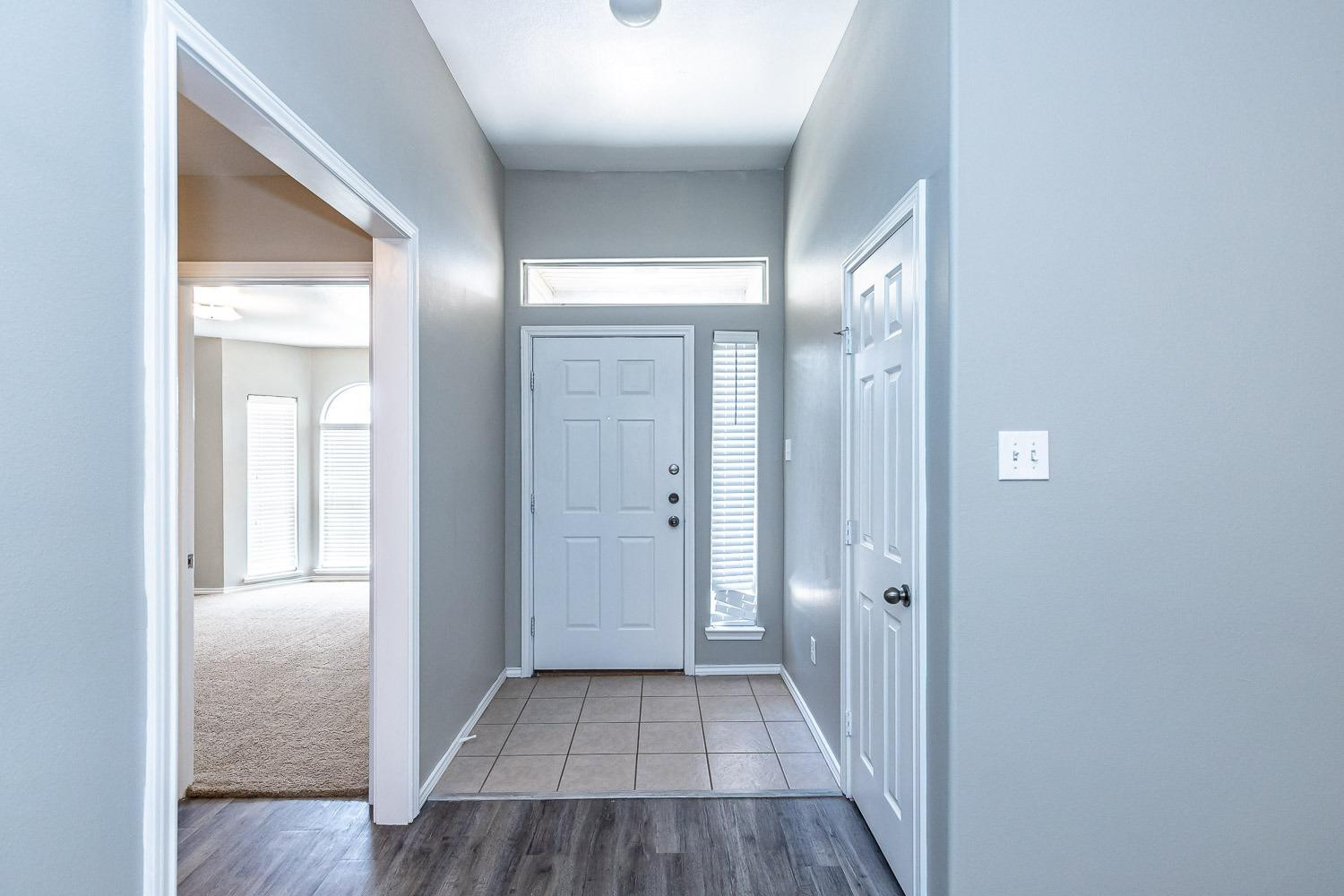 2006 100th Street Lubbock, TX 79423 - Photo 3 of 31 a view of a hallway with wooden floor
