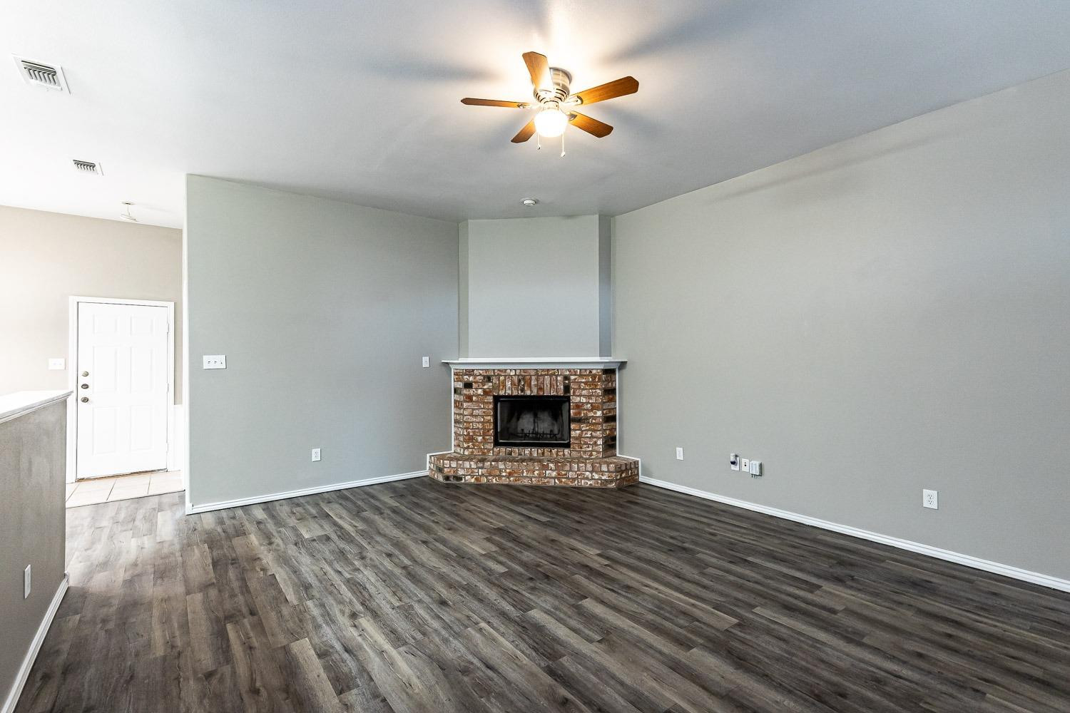 2006 100th Street Lubbock, TX 79423 - Photo 4 of 31 a view of an empty room with window and wooden floor