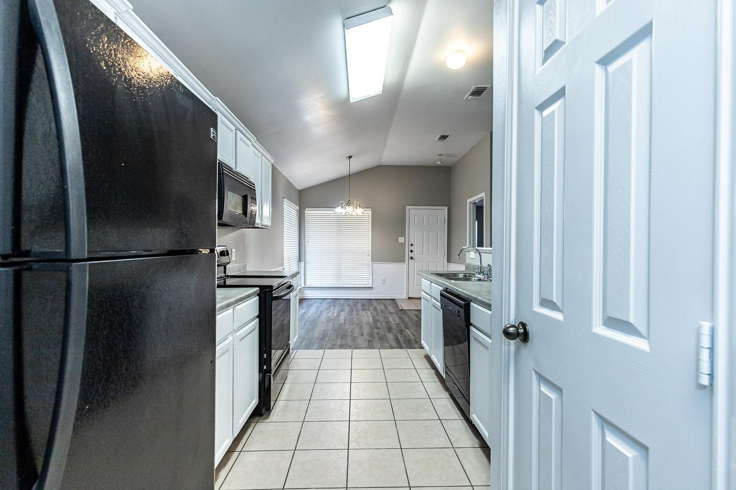 2006 100th Street Lubbock, TX 79423 - Photo 10 of 31 a kitchen with stainless steel appliances granite countertop a refrigerator and a sink