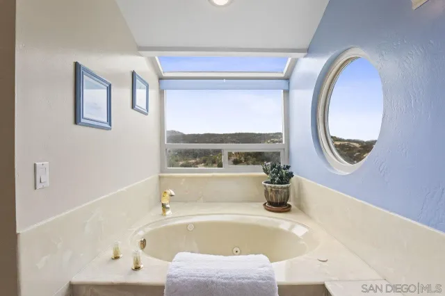 a bathroom with a tub and a window