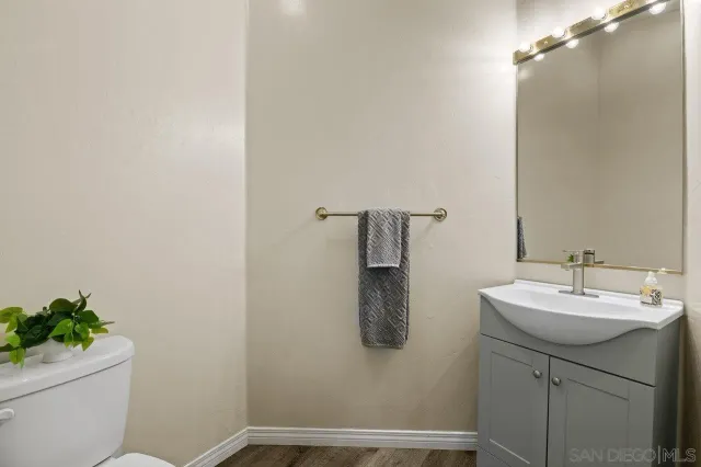 a bathroom with a sink toilet and a mirror