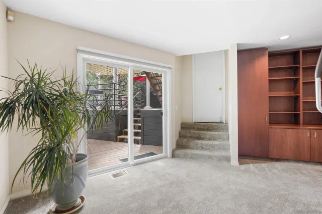 a view of livingroom with wooden floor and a potted plant
