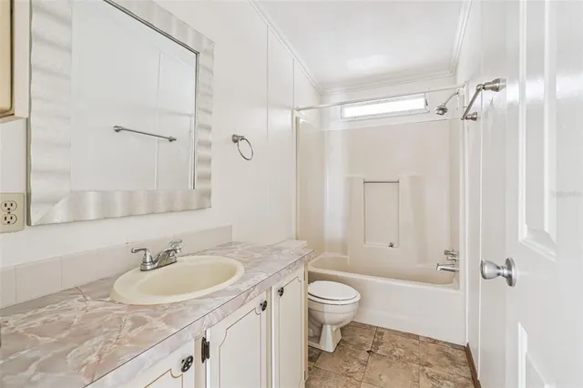 a bathroom with a sink toilet tub and shower