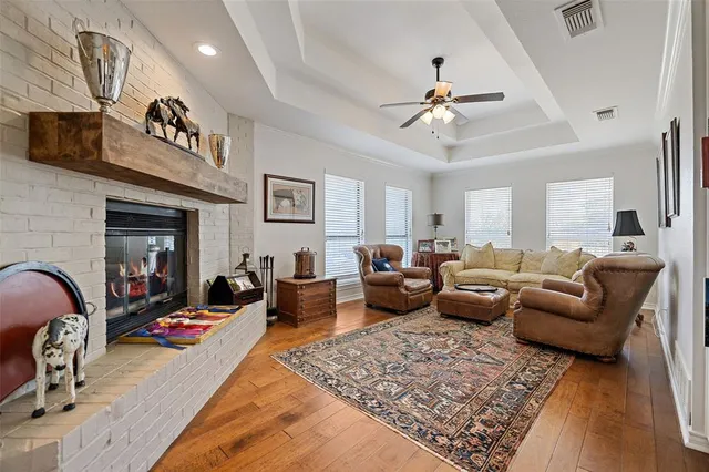 a living room with furniture ceiling fan and a rug