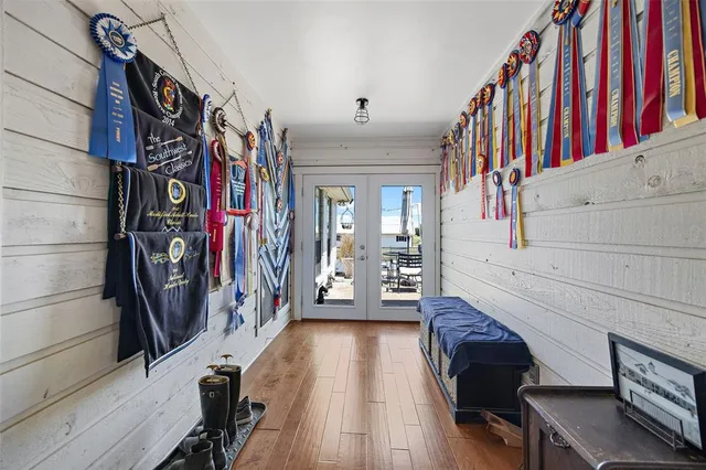 a view of a hallway with wooden floor and entryway