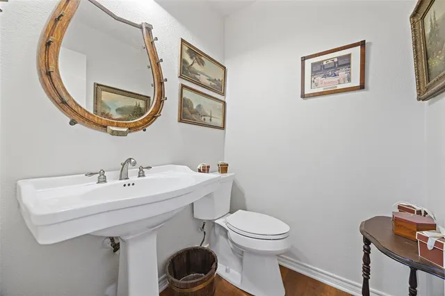 a bathroom with a toilet a sink and a mirror