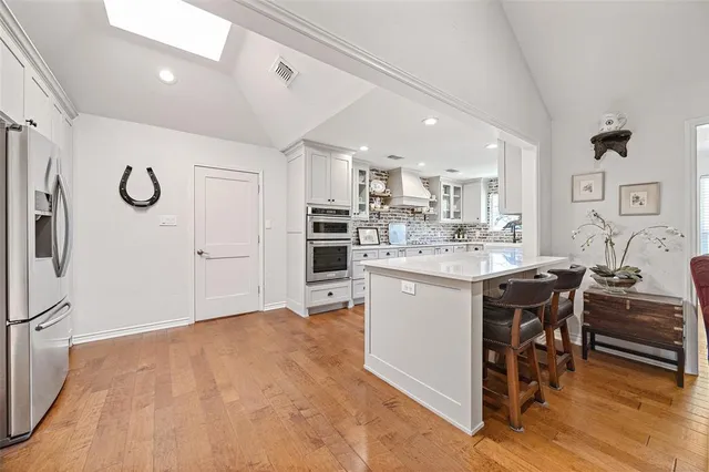 a kitchen with a sink appliances and cabinets