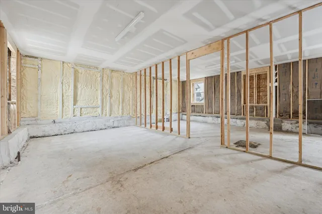a view of an empty room with floor to ceiling window