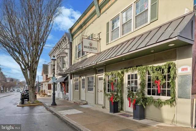 a view of path along with retail shop and buildings