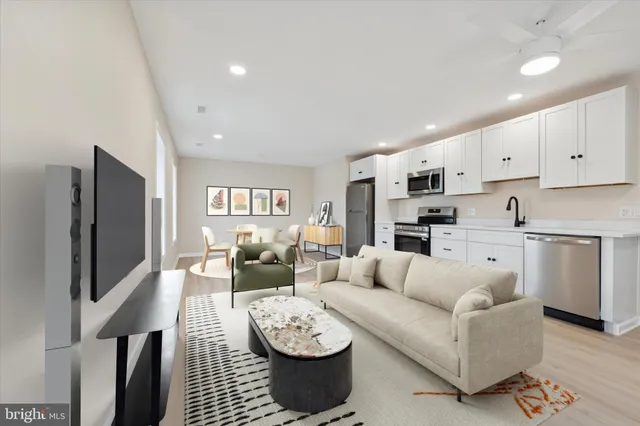 a living room with furniture and a refrigerator