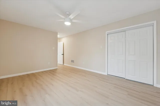a view of an empty room with wooden floor