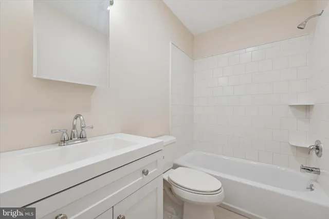 a bathroom with a sink a toilet and a bathtub