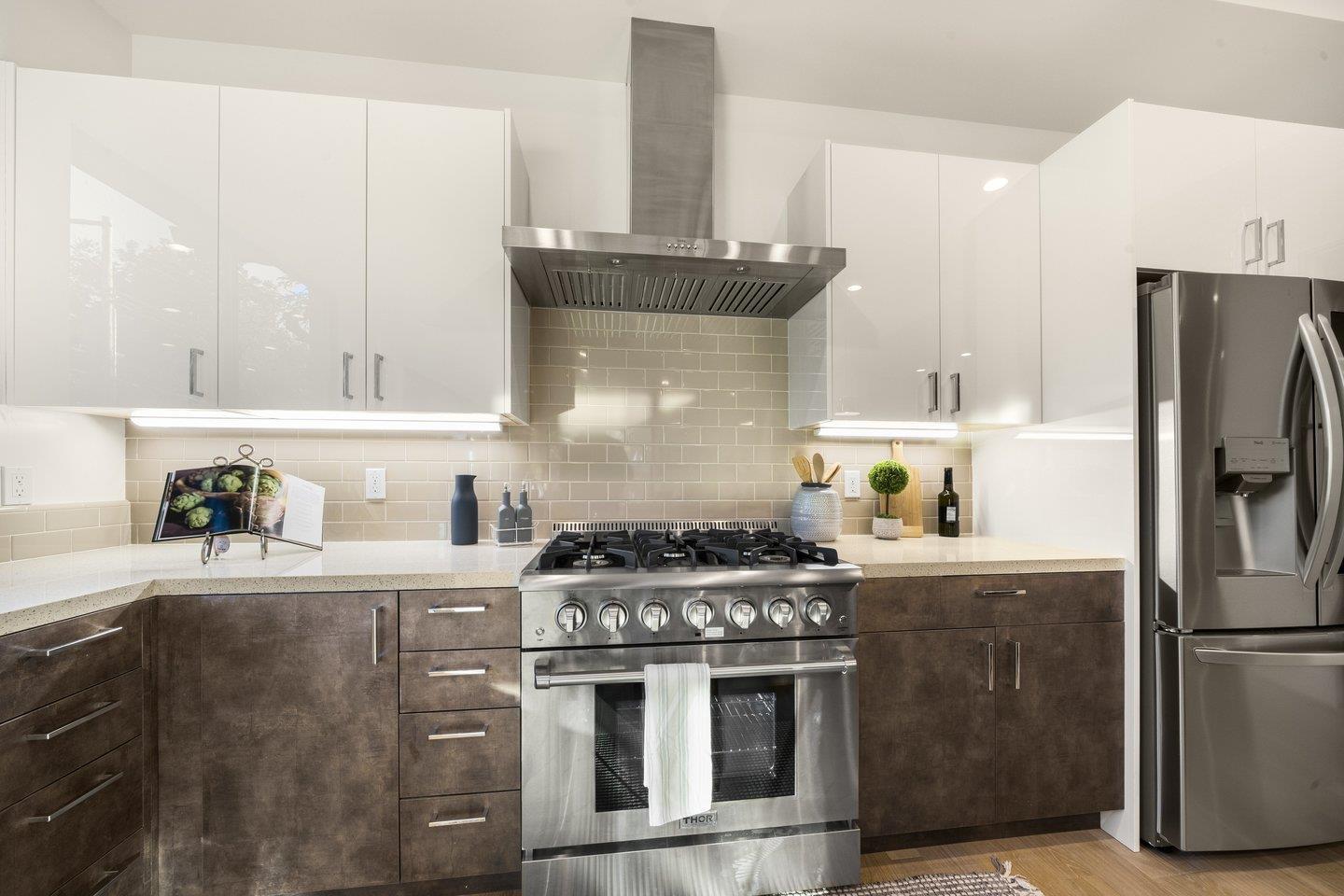 1009 Cascade Drive Sunnyvale, CA 94087 - Photo 19 of 89 a kitchen with stainless steel appliances granite countertop a stove a refrigerator and a refrigerator with wooden cabinets