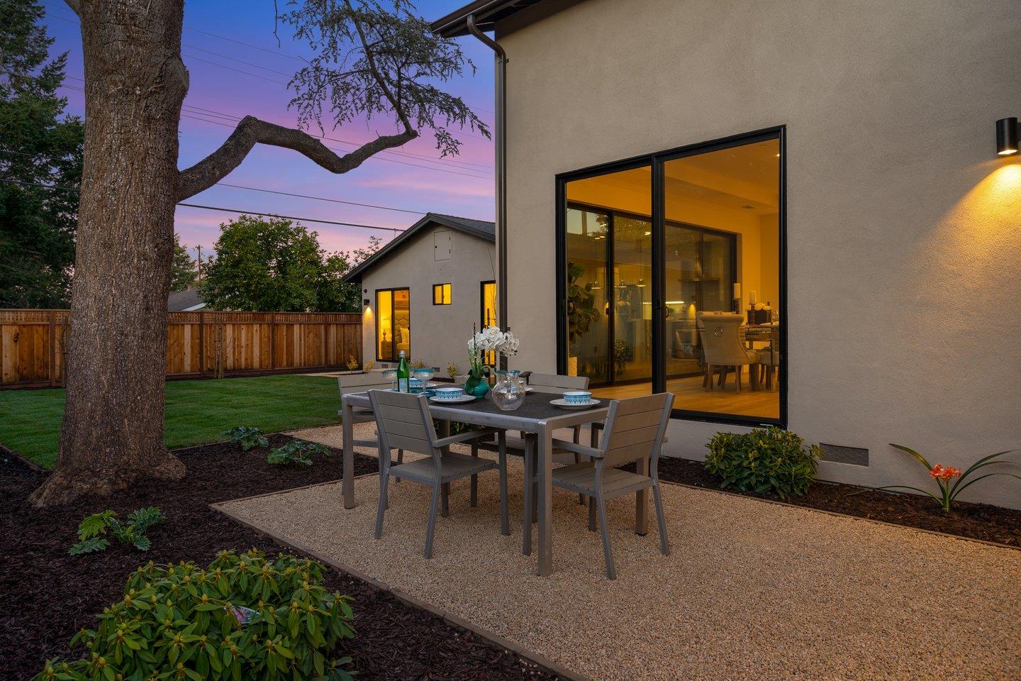 1009 Cascade Drive Sunnyvale, CA 94087 - Photo 78 of 89 a view of a patio with table and chairs with plants and wooden fence