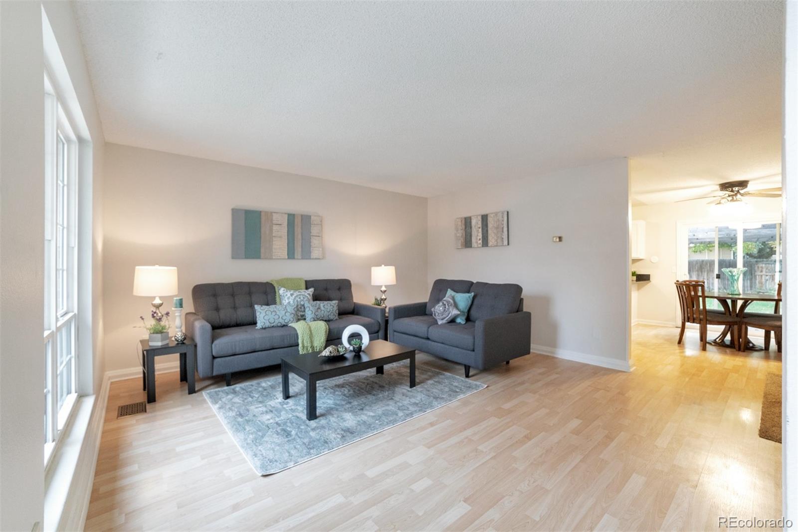 9575 Carr Street Westminster, CO 80021 - Photo 1 of 25 a living room with furniture and a table