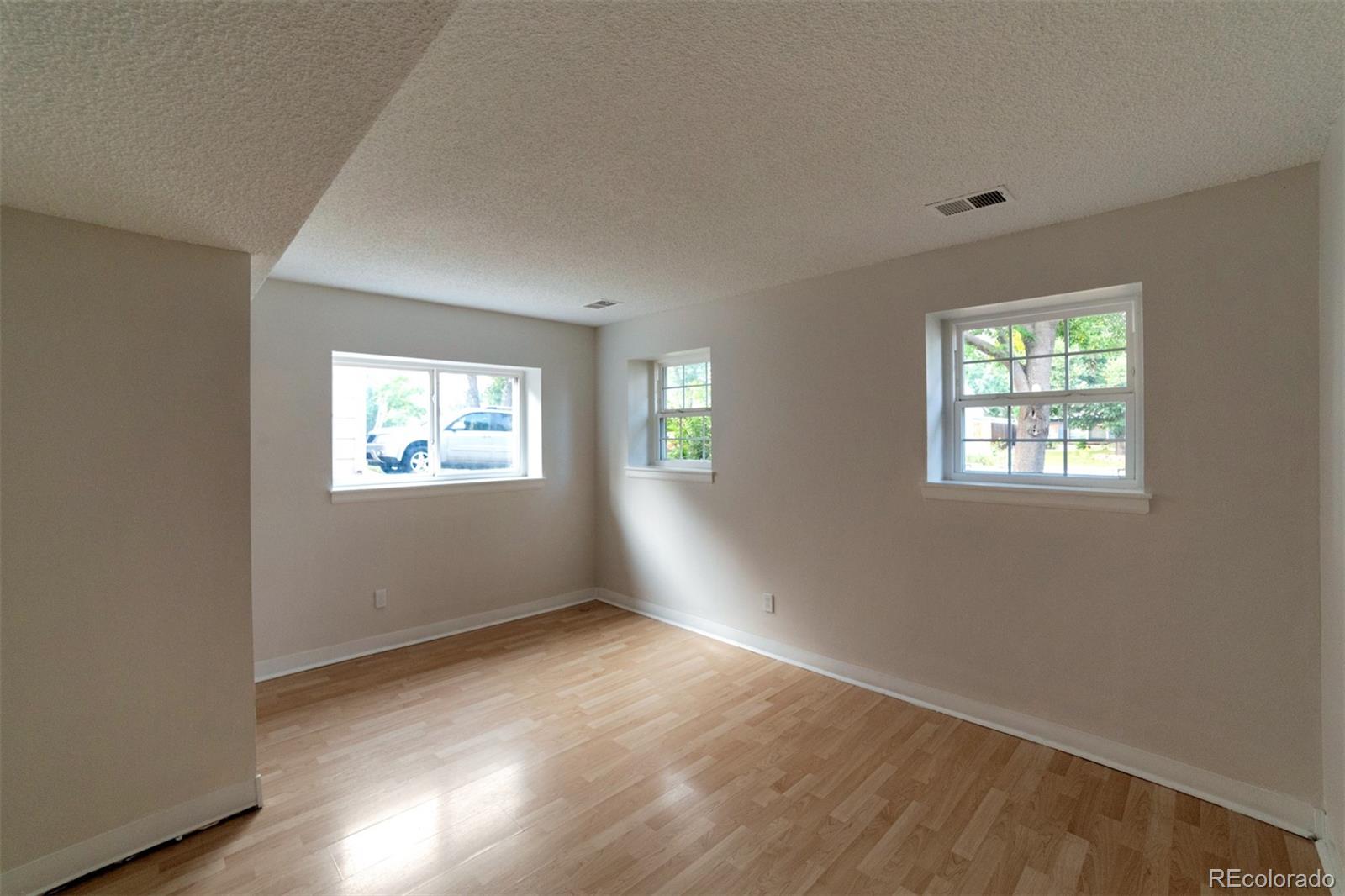 9575 Carr Street Westminster, CO 80021 - Photo 15 of 25 a view of an empty room with wooden floor and a window