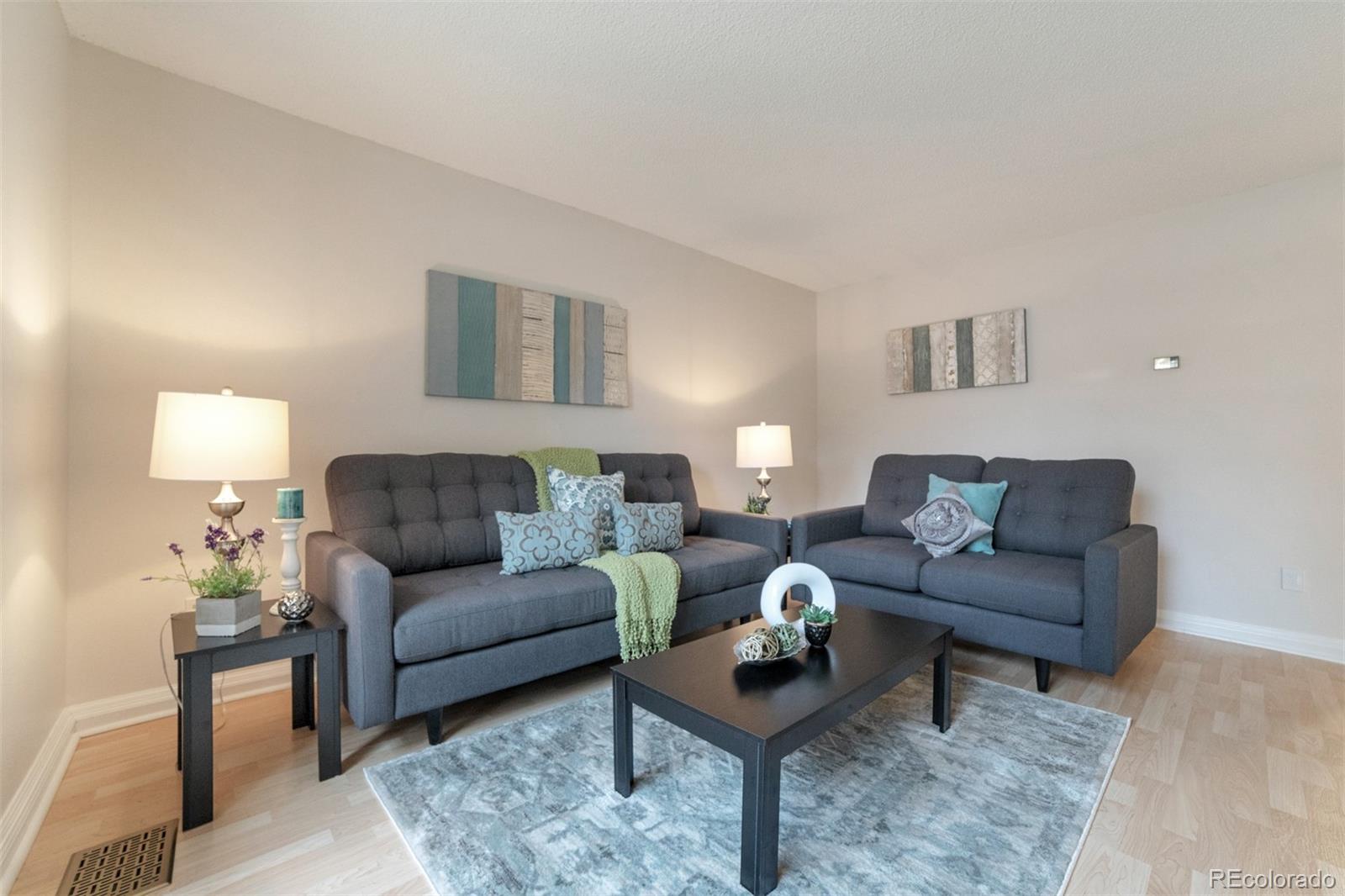 9575 Carr Street Westminster, CO 80021 - Photo 2 of 25 a living room with furniture and a lamp