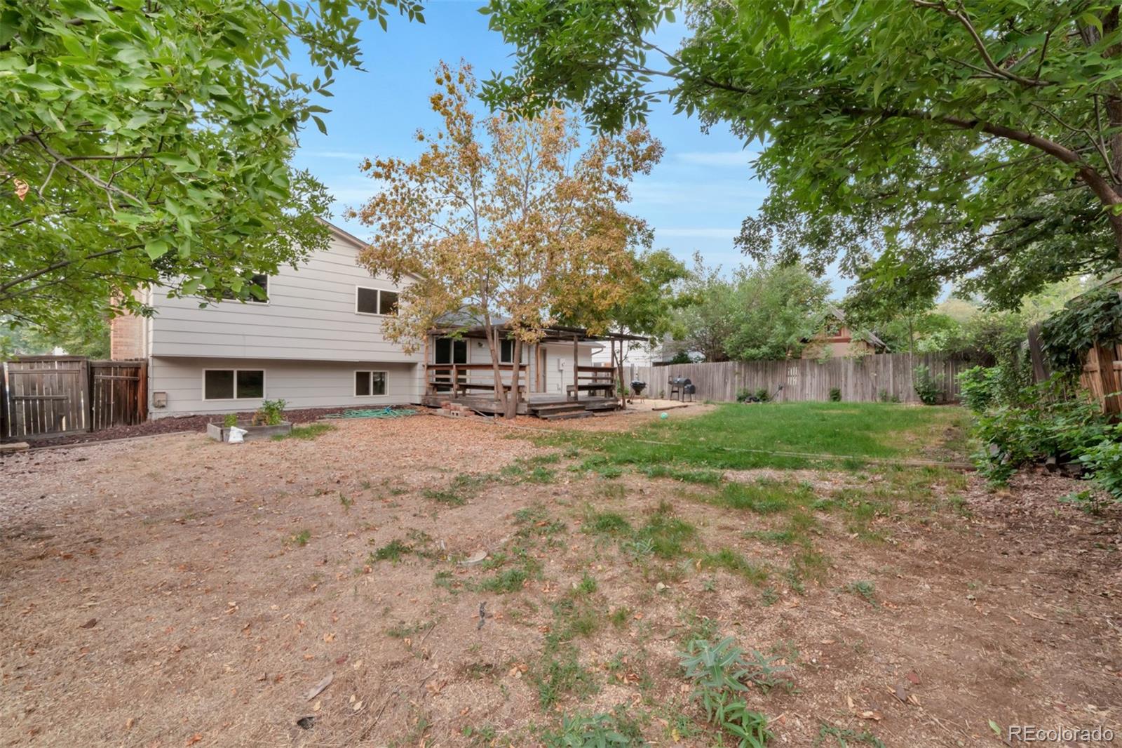 9575 Carr Street Westminster, CO 80021 - Photo 21 of 25 a front view of a house with garden