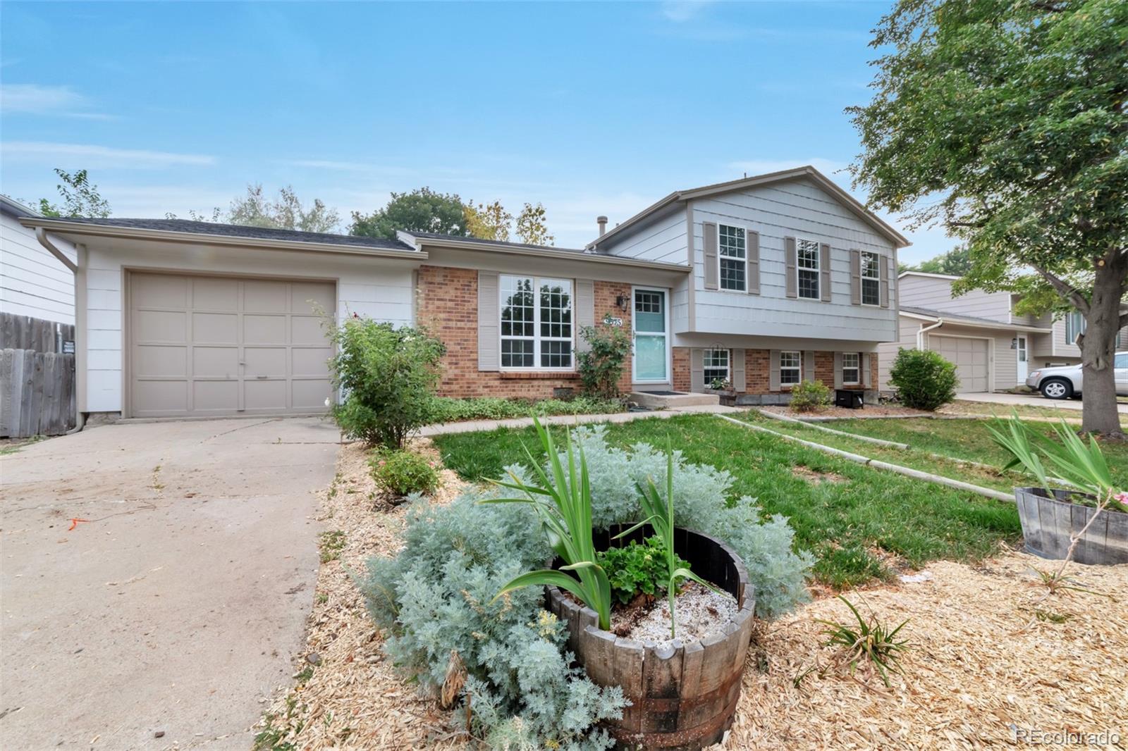 9575 Carr Street Westminster, CO 80021 - Photo 25 of 25 a front view of a house with a yard