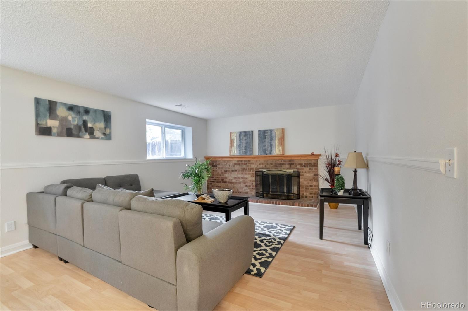 9575 Carr Street Westminster, CO 80021 - Photo 5 of 25 a living room with furniture and a flat screen tv