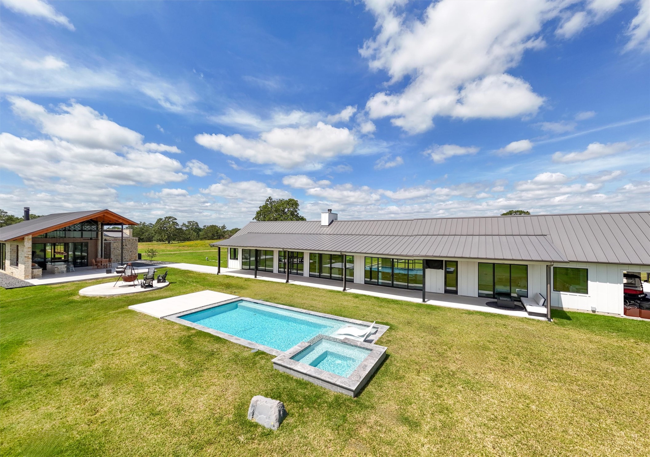 1629 Waldeck Road Ledbetter, TX 78946 - Photo 5 of 50 Rear view of the Main House, Pool House,
firepit and pool.
