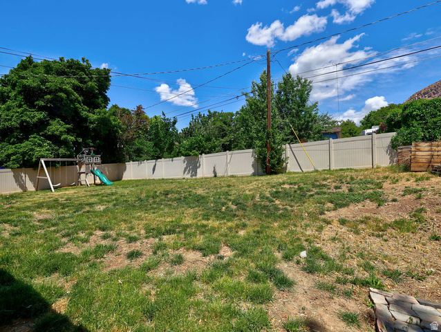 1272 Cook Street Ogden, UT 84404 - Photo 38 of 46 Expansive backyard featuring a partial vinyl privacy fence and mature perimeter trees